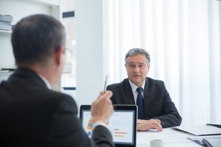 Business professionals in a focused discussion during an office meeting.
